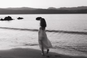 Black and white photo series showing silhouettes of people walking and standing along a serene beach at sunset.