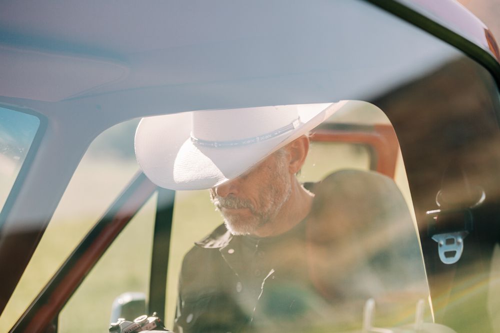 A series of photos showing a person sitting in a car while wearing a cowboy hat and sunglasses.