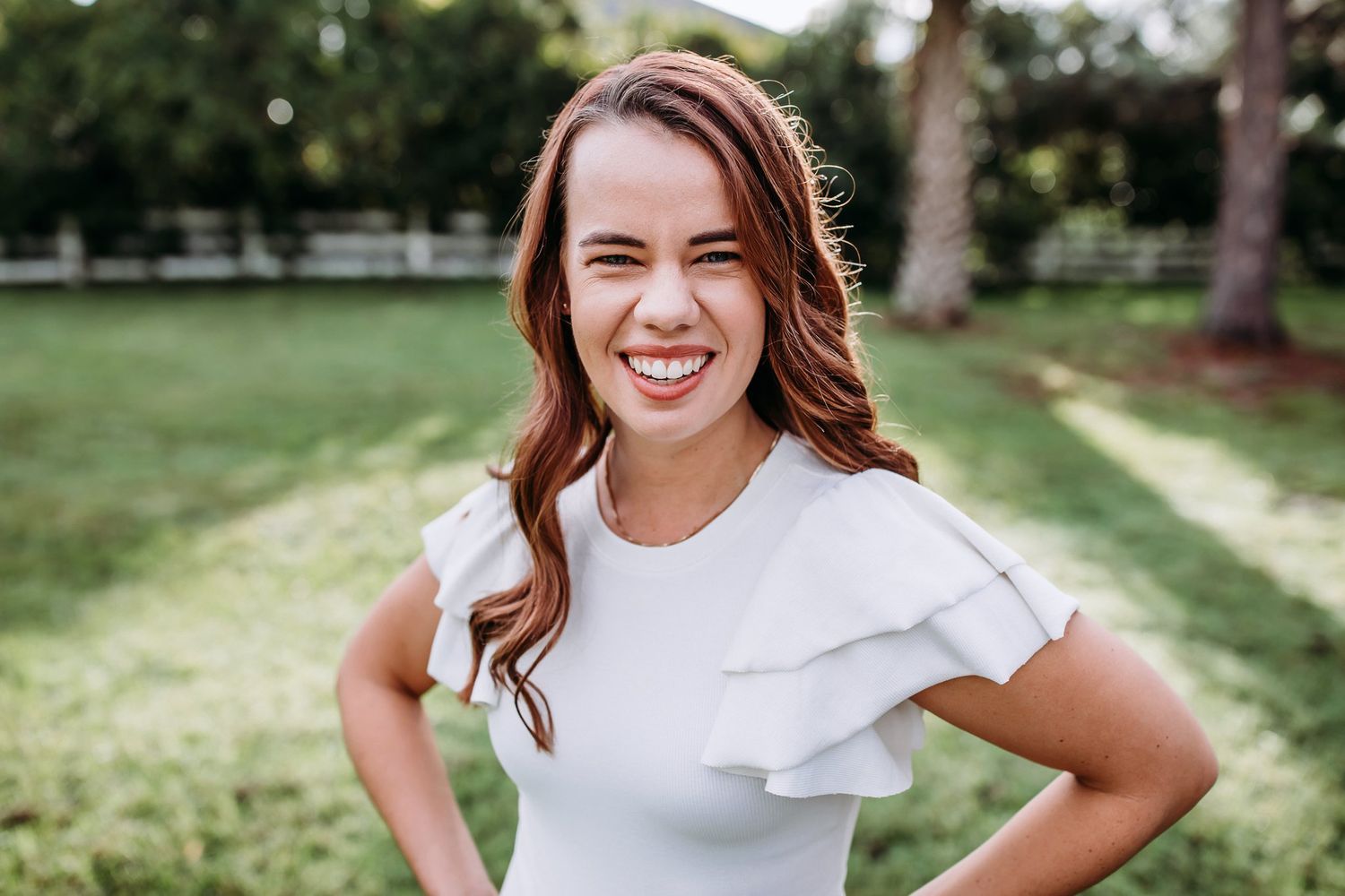 A series of outdoor portrait photographs showing someone in a white dress posing in a sunlit garden setting.