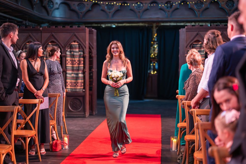 Formal event venue decorated with string lights and red carpet for special occasion.
