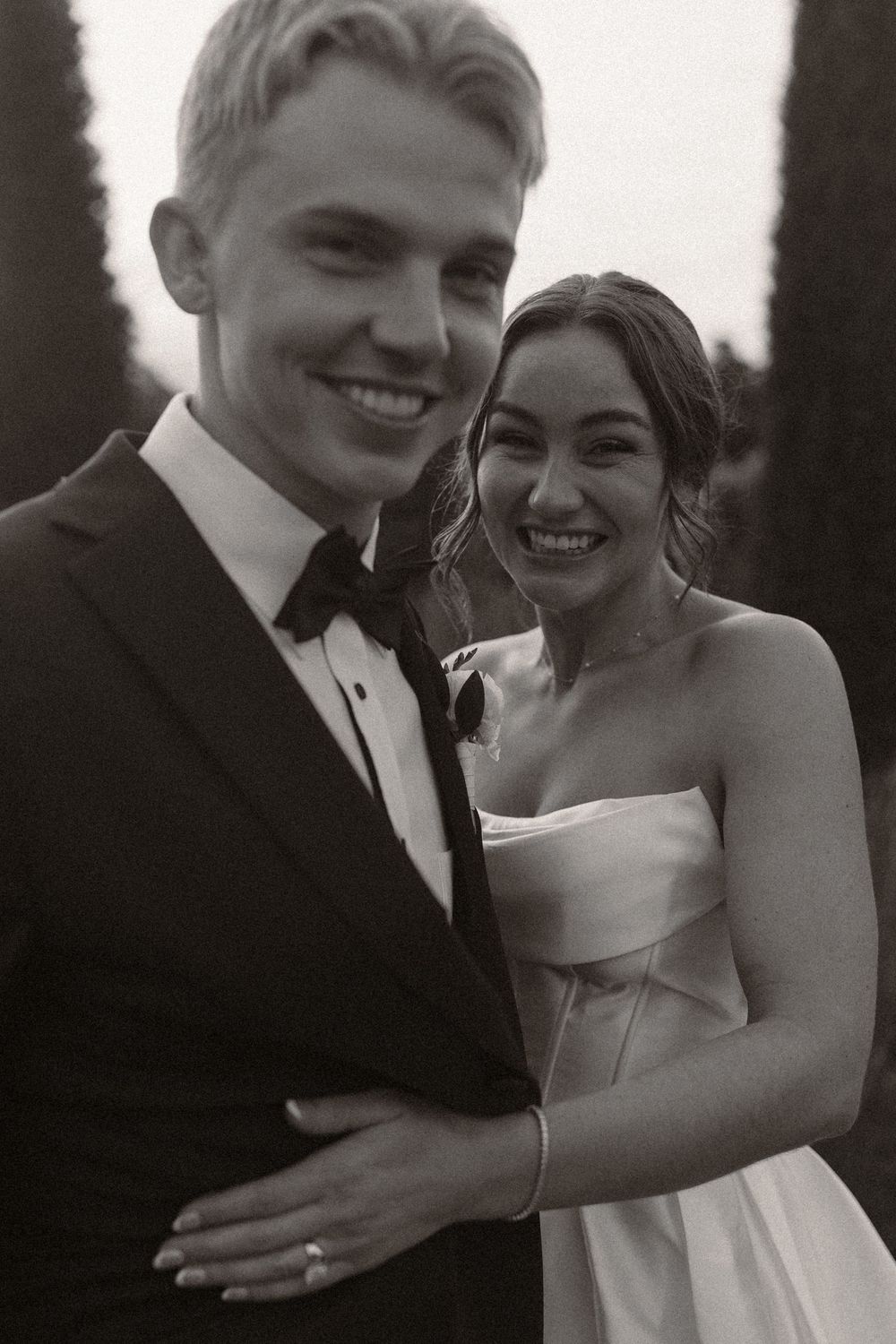 Black and white portrait of newlyweds sharing joyful laughter together.