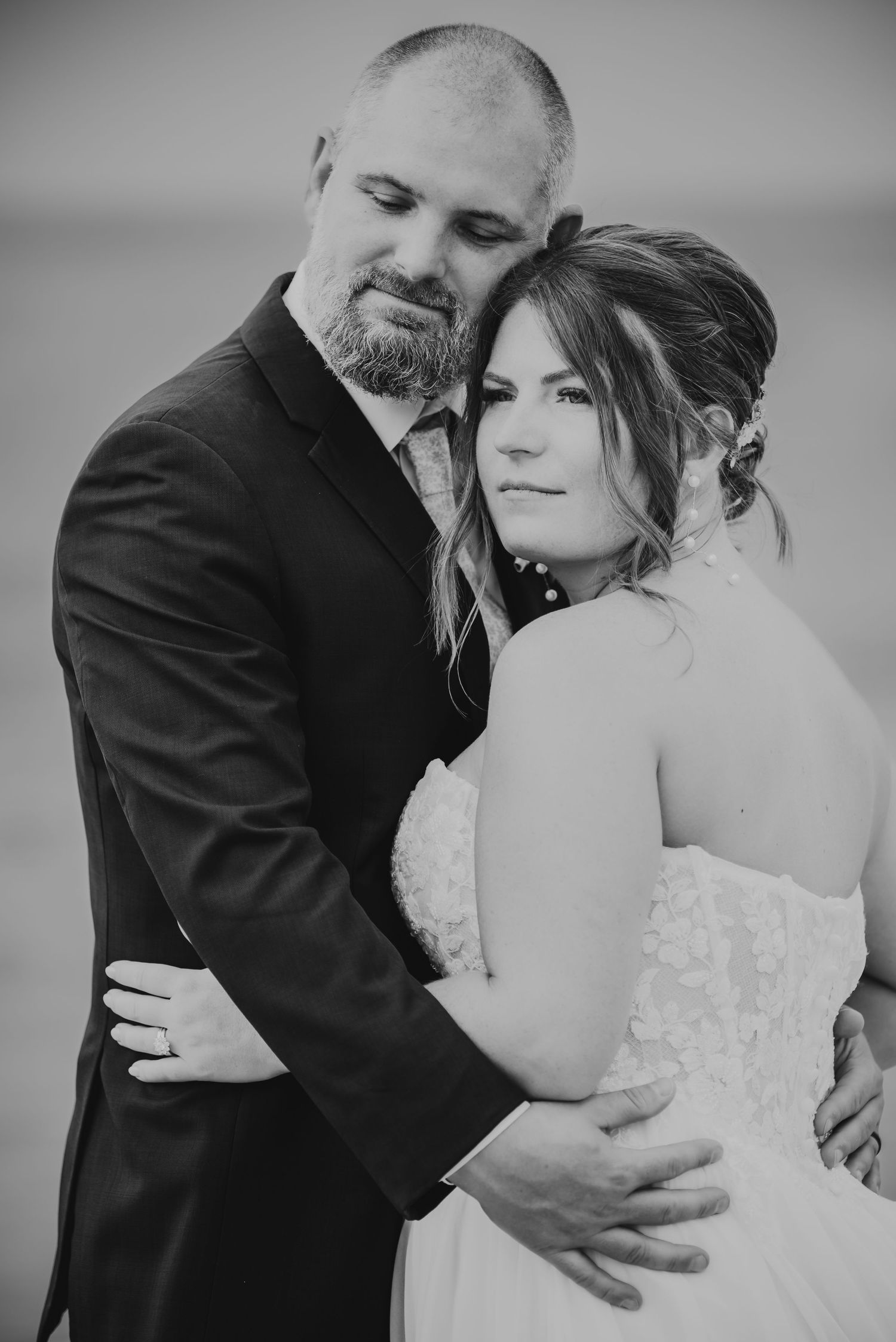 A black and white series of romantic wedding portraits showing tender moments between a couple.