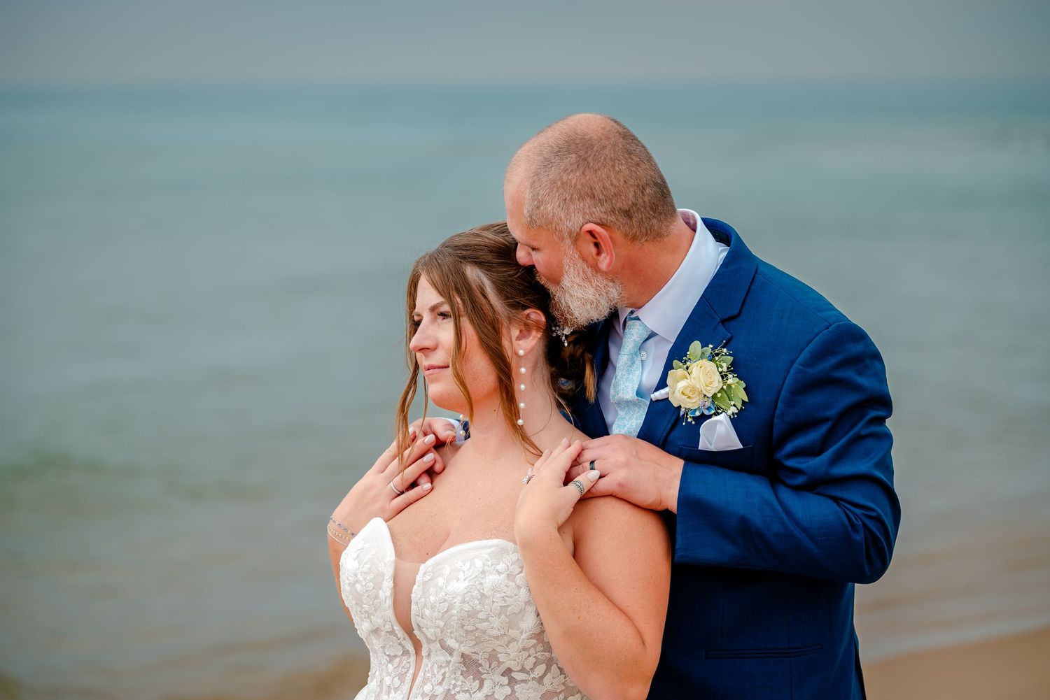 Romantic beachside wedding portraits with couple sharing intimate moments.