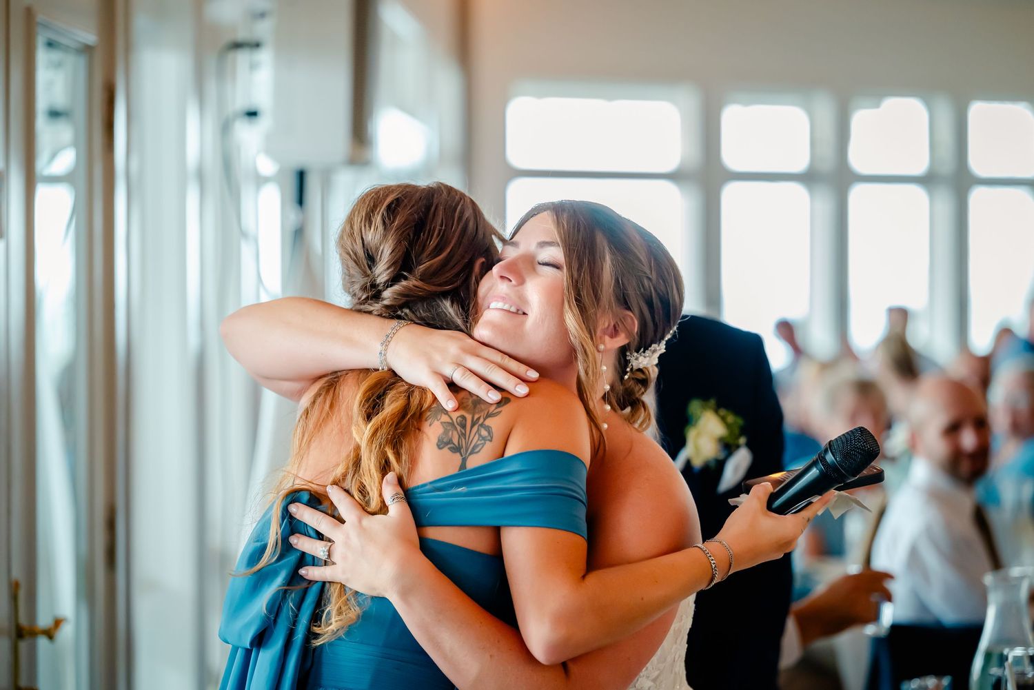 Joyful wedding reception moments with guests sharing embraces and celebrations.