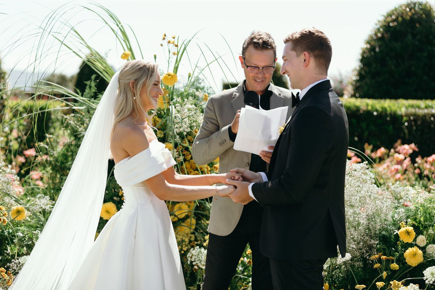 A series of outdoor wedding ceremony moments showing a couple exchanging vows in a sunny garden setting.