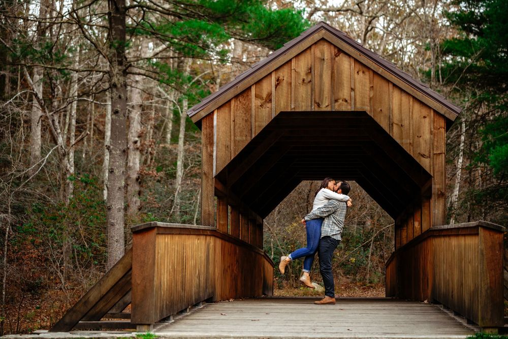 A rustic wooden covered bridge in a forest setting photographed from multiple angles during different seasons.