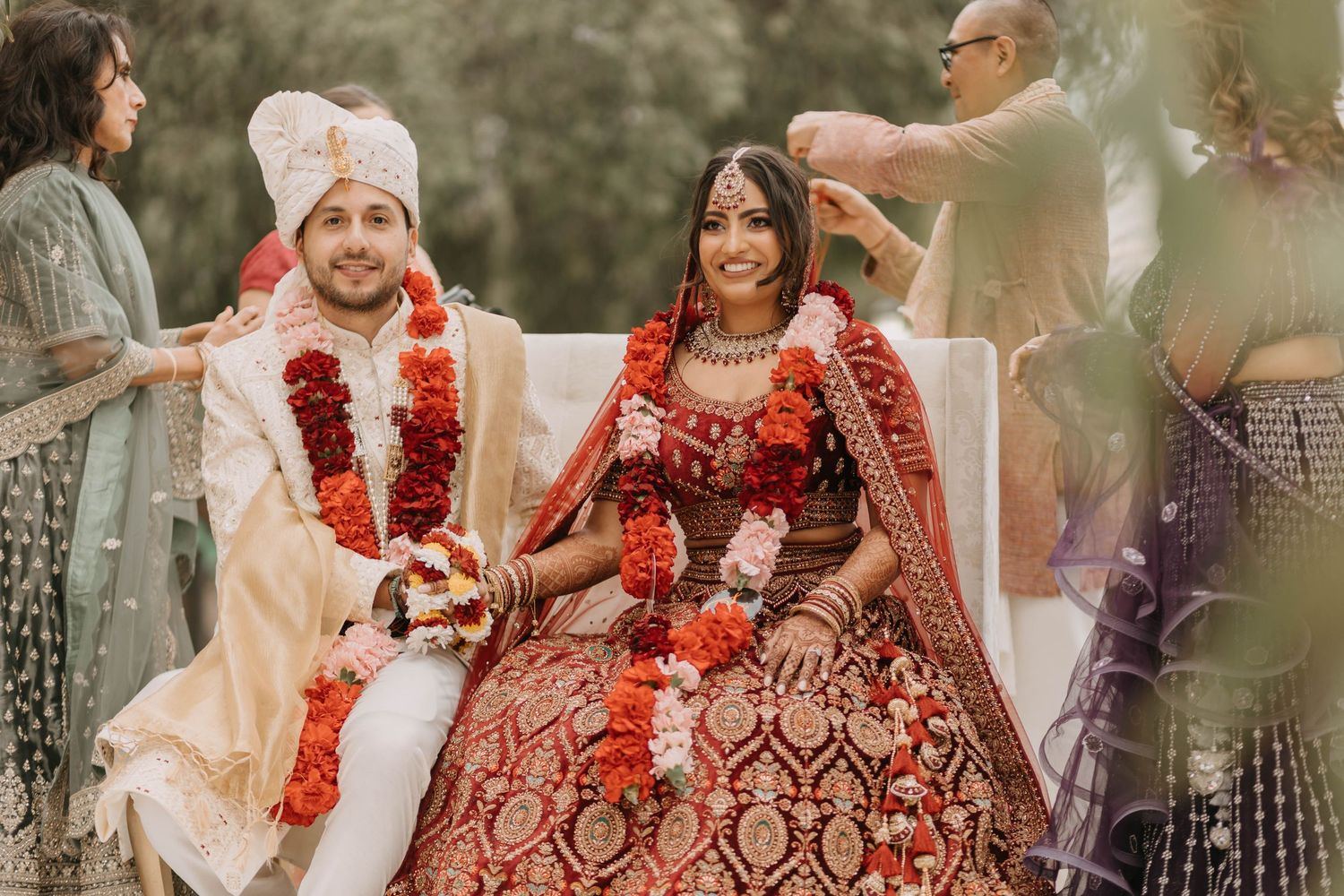 Traditional Indian wedding ceremony with ornate floral decorations and warm lighting creating a romantic atmosphere.