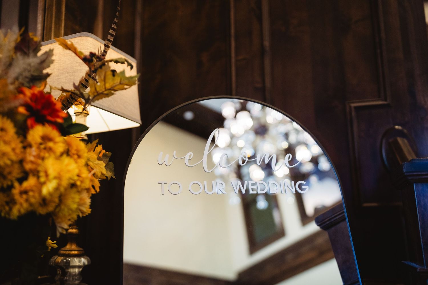 Elegant wedding reception venue with dark wood beams and warm lighting creating an intimate atmosphere.