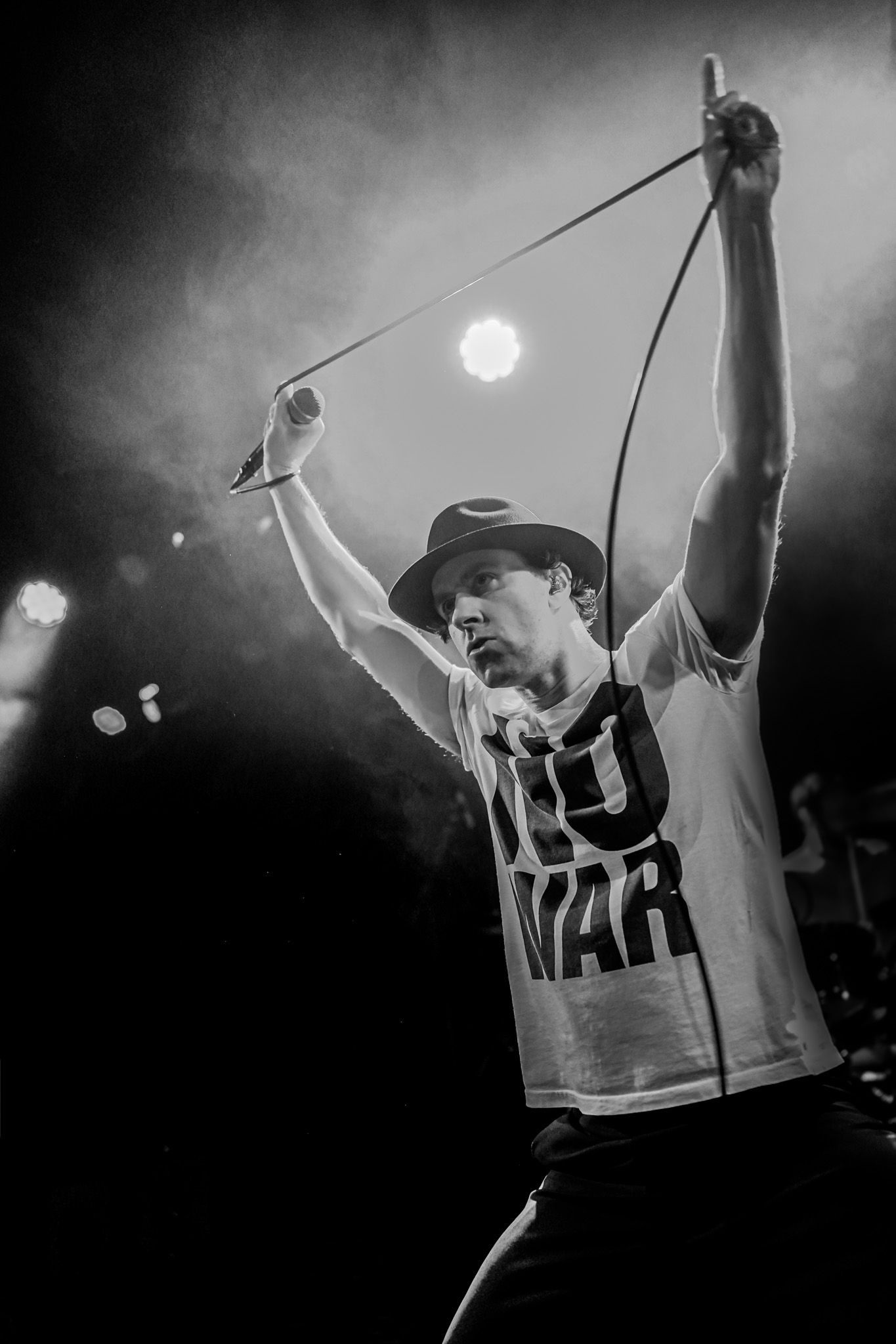 Dynamic black and white concert photography sequence showing energetic stage performance with dramatic lighting and movement.