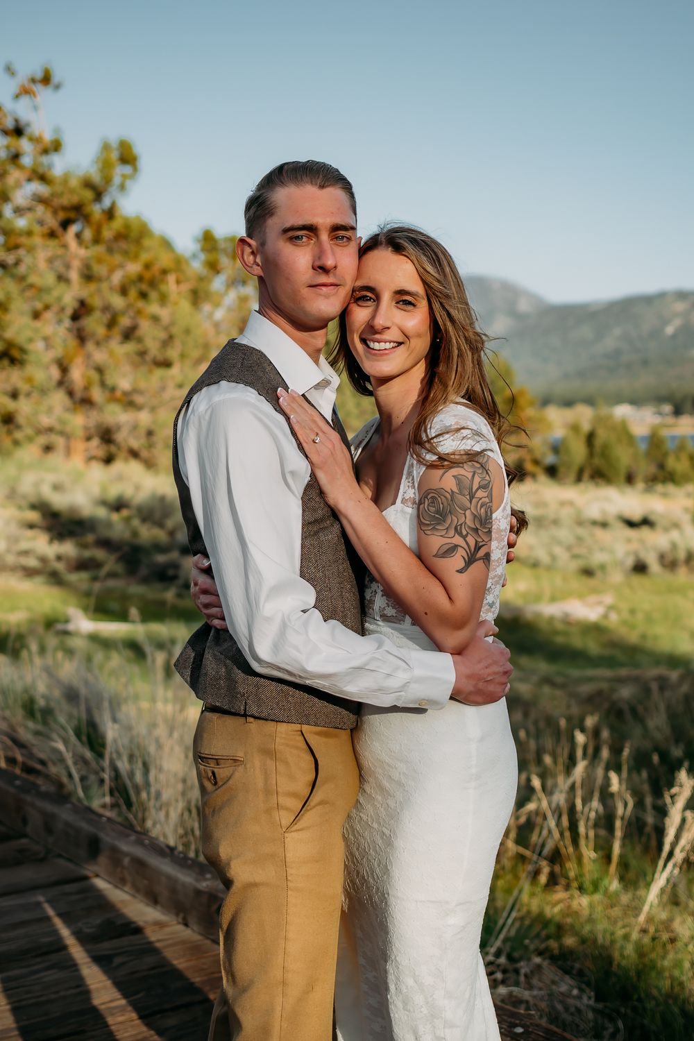 Elegant outdoor portraits in desert setting with mountain backdrop.