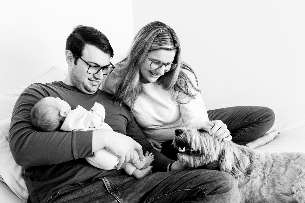 Black and white collage of intimate family moments with a baby on a couch.