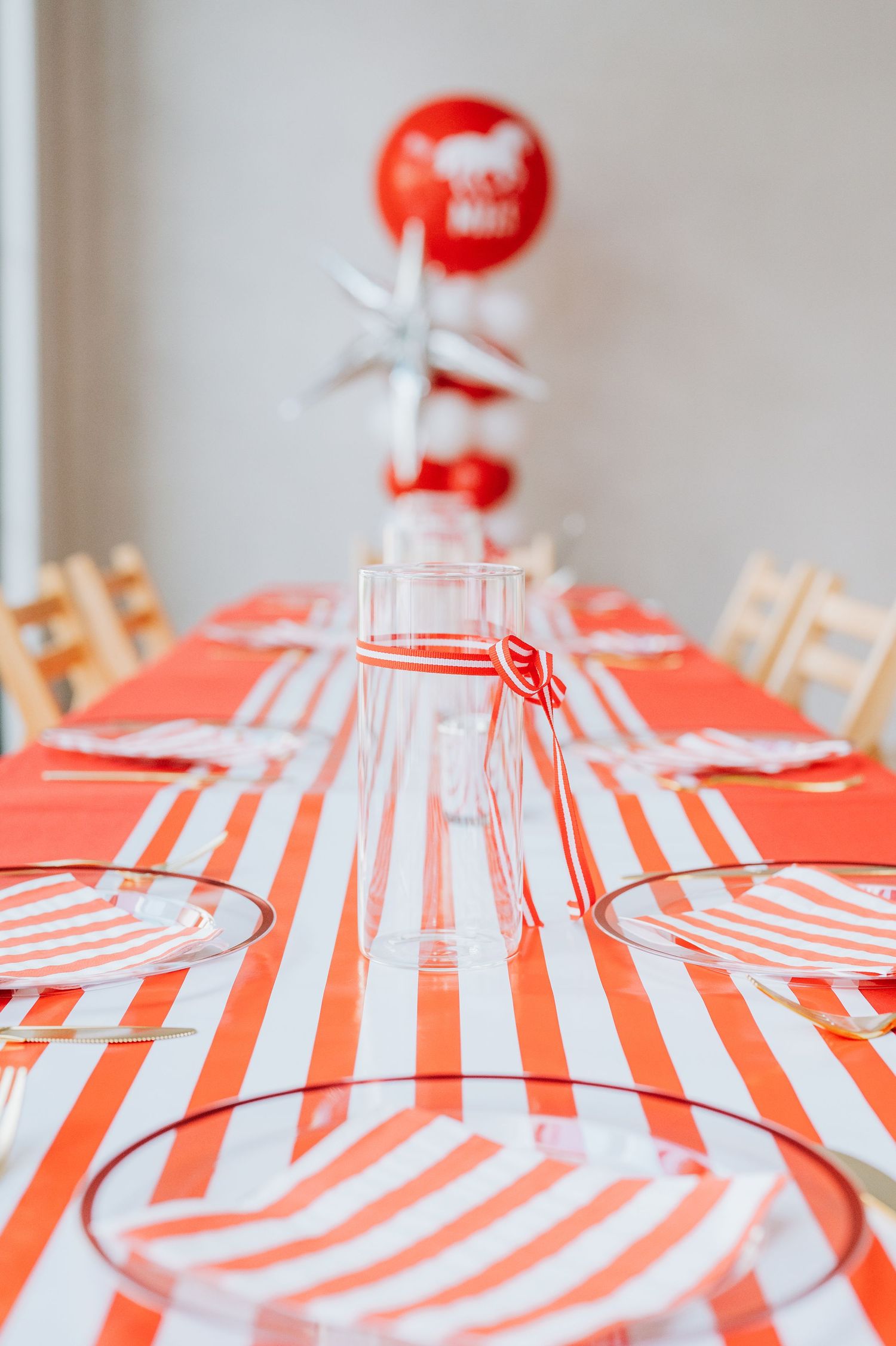 Red and white striped beach umbrellas lined up in a row creating a festive summer pattern. Homecoming Photographer near me
