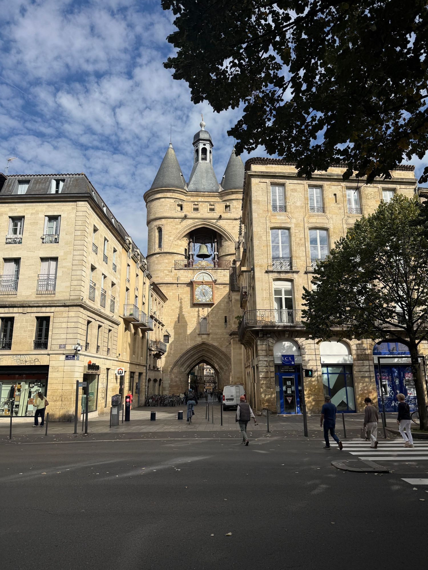 Panoramic view of historic French town square with classic architecture and stone buildings.