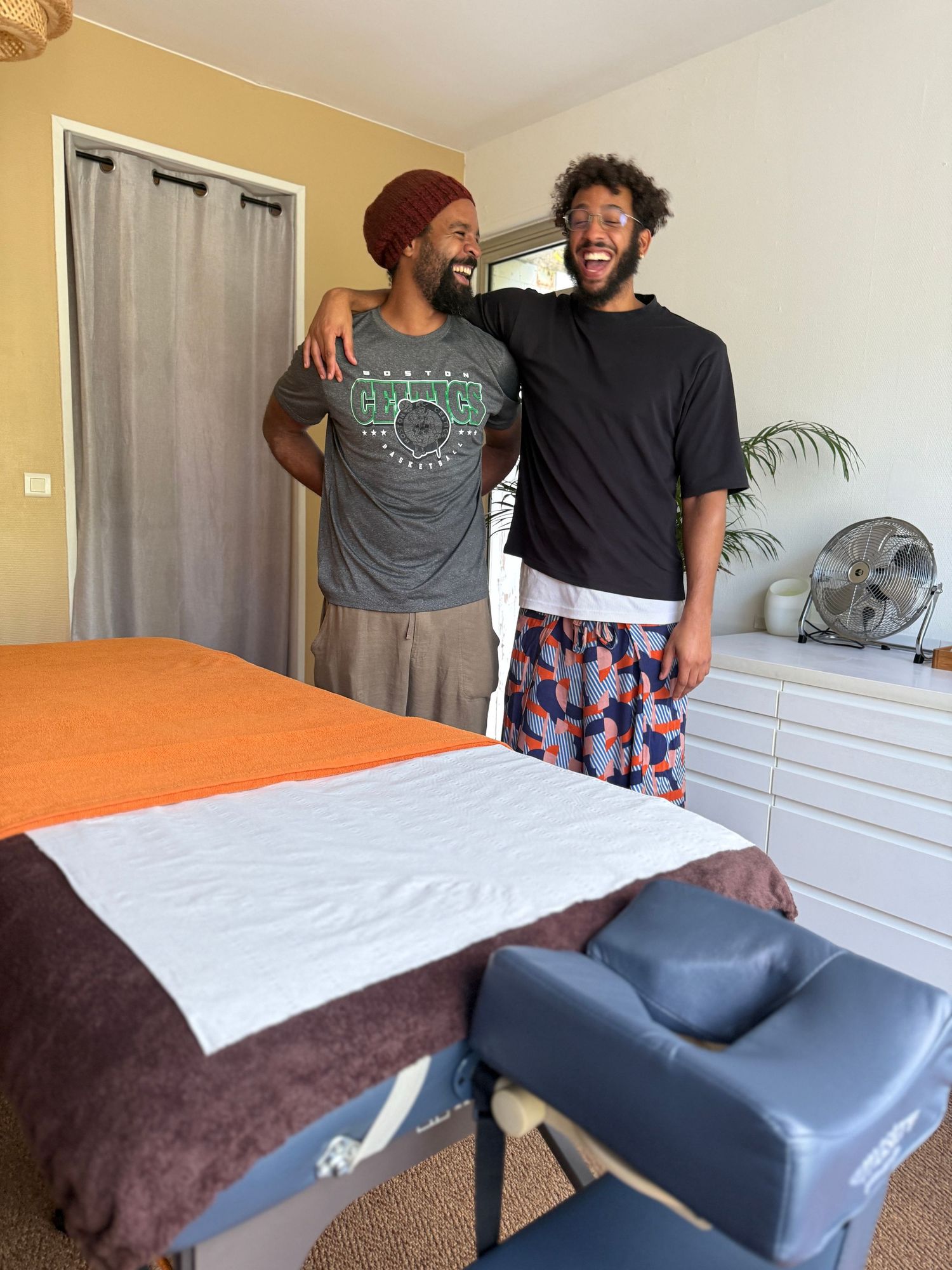 Series of photos showing massage therapy room setup with white sheets and orange accents.