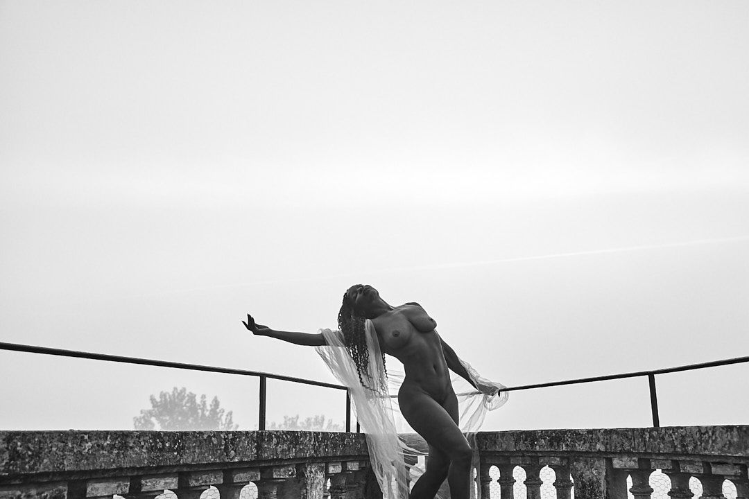 Artistic black and white silhouettes on a stone balcony wall.