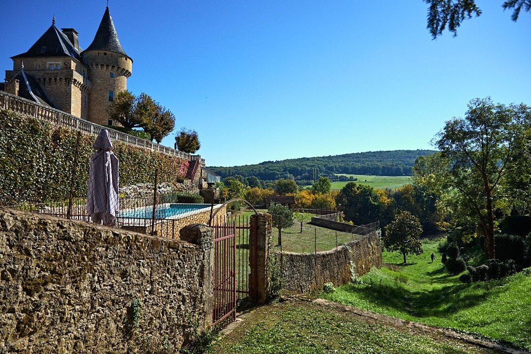 Panoramic view of stone walls and countryside landscape under blue sky.