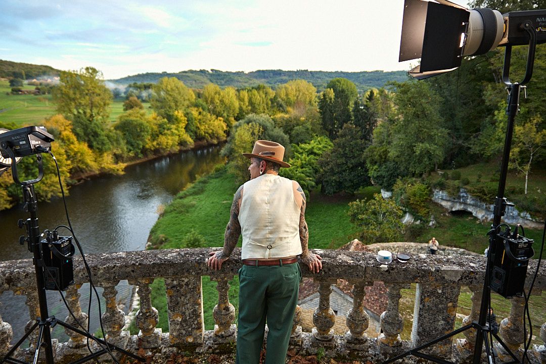 Panoramic view of rolling hills and river valley from historic stone balcony.