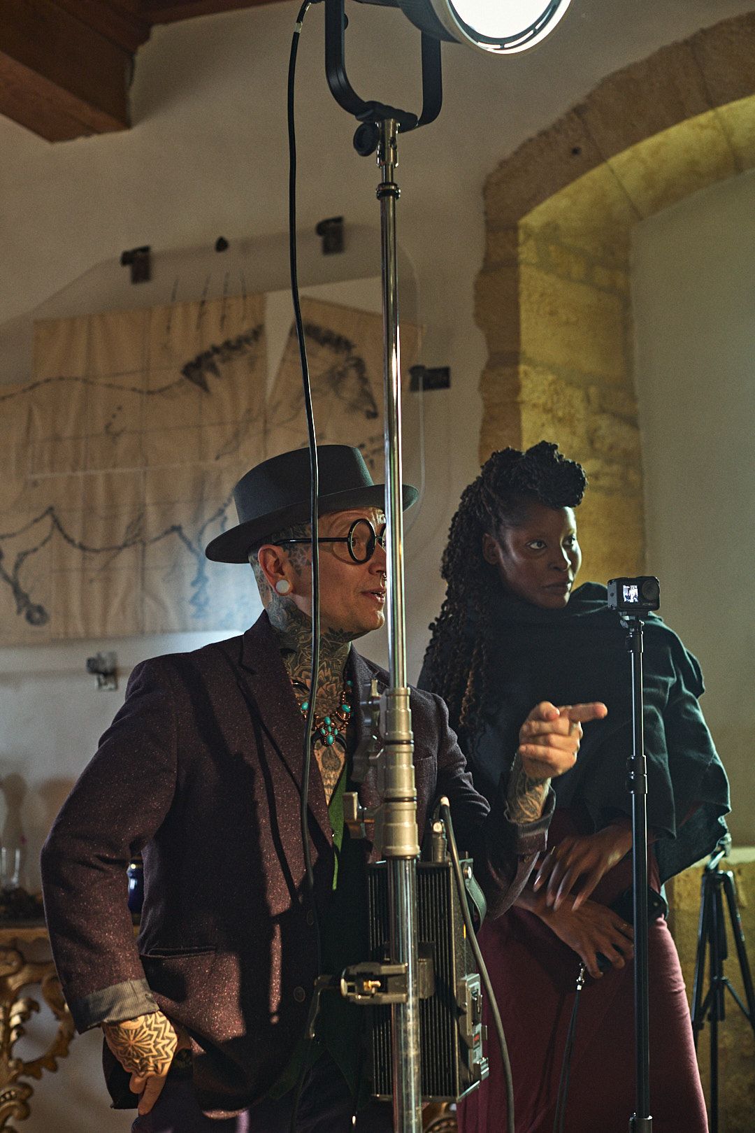 Behind the scenes of a vintage-styled photo shoot with professional lighting equipment.