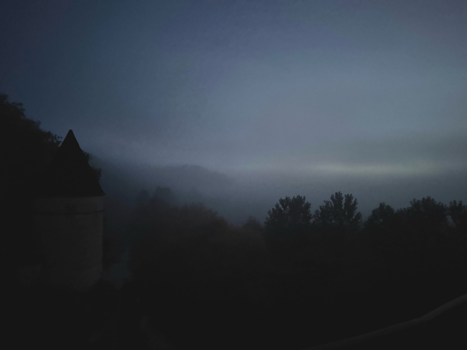 Dark moody landscape photos showing silhouettes of trees against a dusky sky.