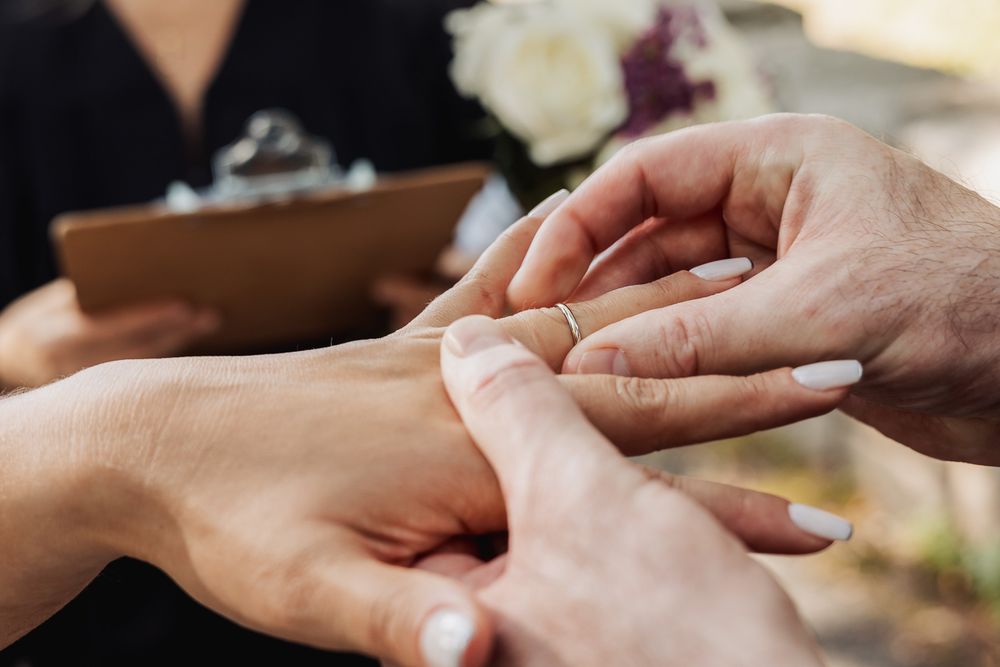 Close-up view of hands holding each other in a comforting gesture showing support and connection.