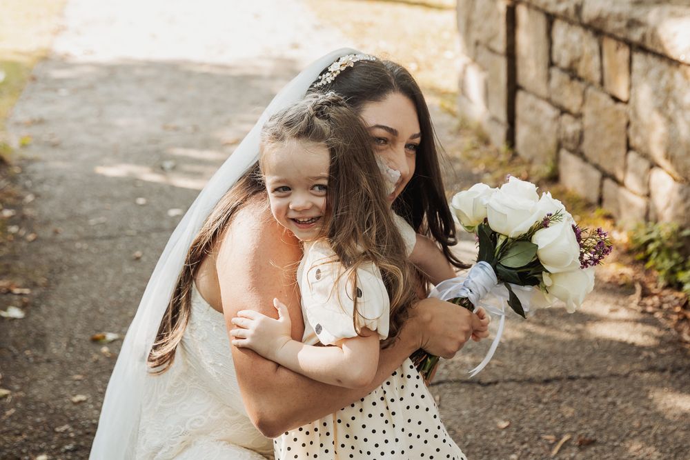 A series of candid wedding photos showing tender moments between couples in an outdoor setting with stone walls.