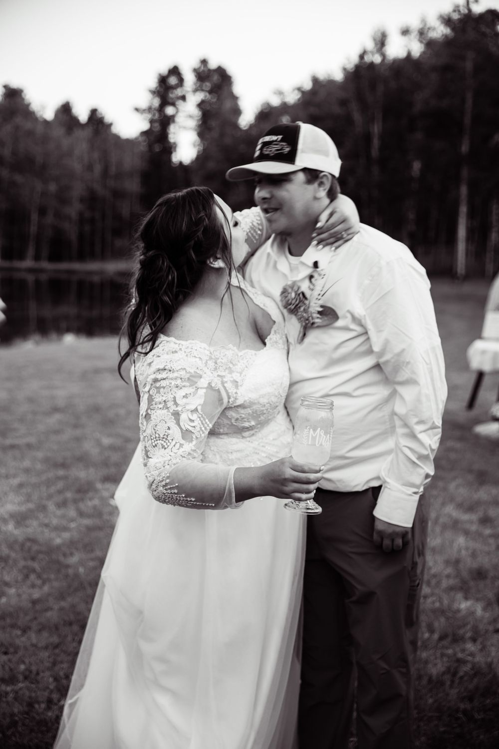Black and white romantic wedding portrait in an outdoor setting.
