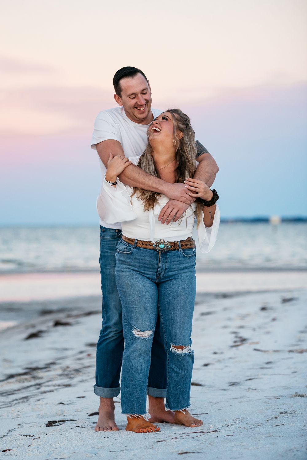 Young couple enjoying the cotton candy skies and each others company.