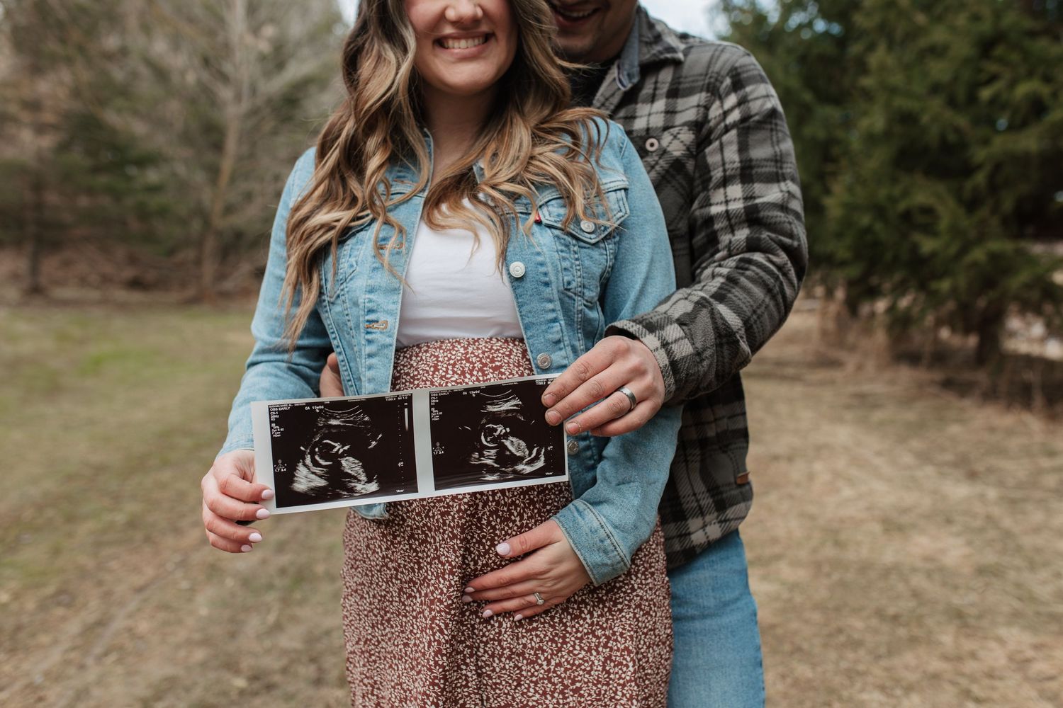 A couple shares a special moment holding their first ultrasound photo together.