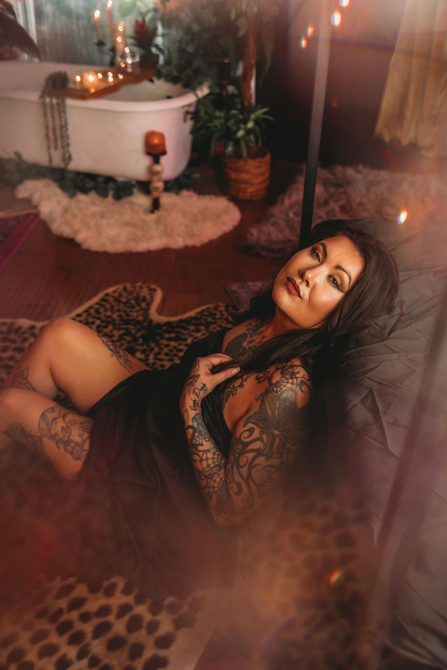 Cozy boudoir setting with leopard print rug and ambient candlelight.
