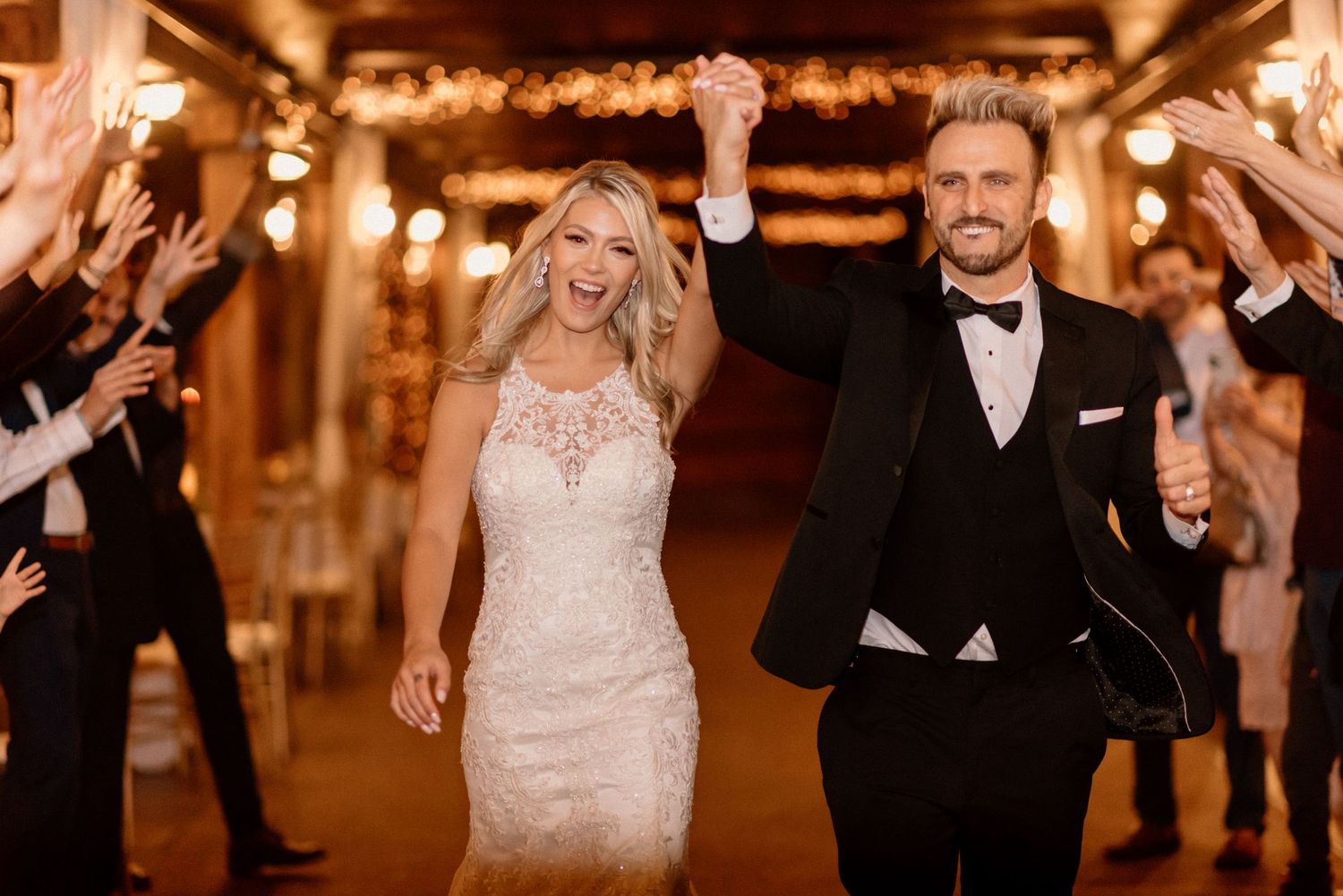 Romantic evening wedding reception with couples dancing under warm lighting.
