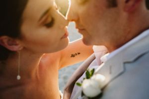 A romantic wedding photo sequence showing a couple kissing in different poses with soft lighting and elegant attire.
La Valise Tulum