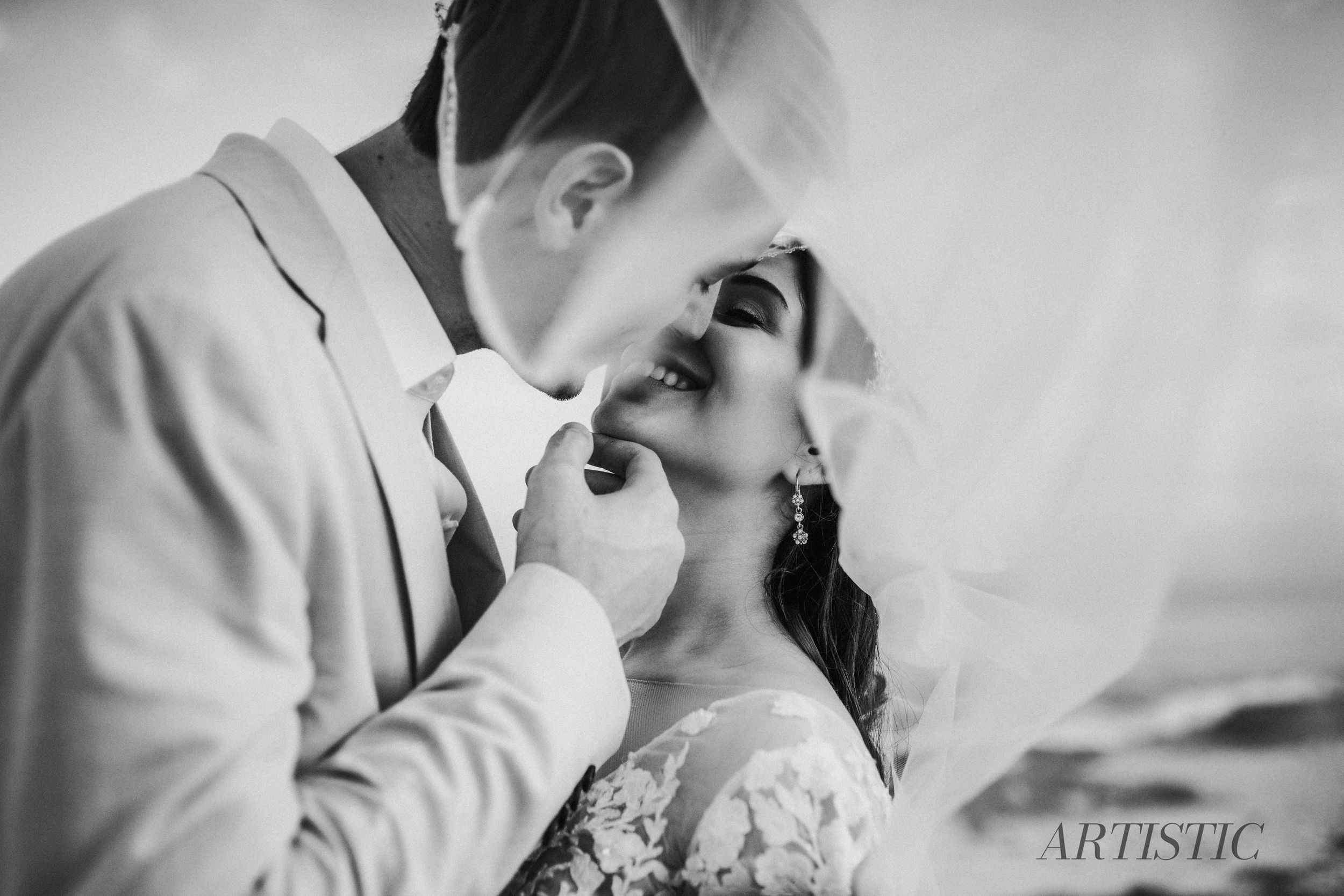 A romantic black and white wedding photo captures an intimate moment between newlyweds during their first dance.