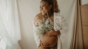A series of maternity photos showing a pregnant woman in white lace against a warm neutral backdrop.