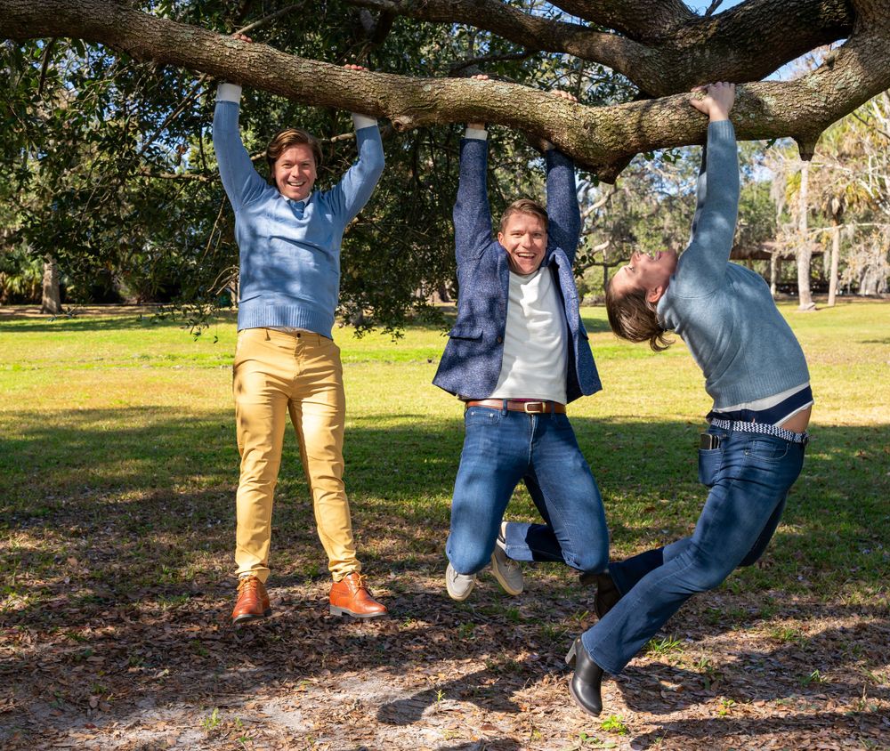 Playful group shots showing feet and legs under tree branches.