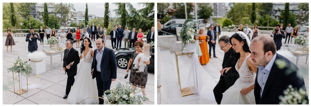Wedding guests dancing and celebrating outdoors surrounded by white floral arrangements.