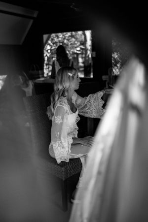 Artistic black and white photo of wedding preparation through lace details.