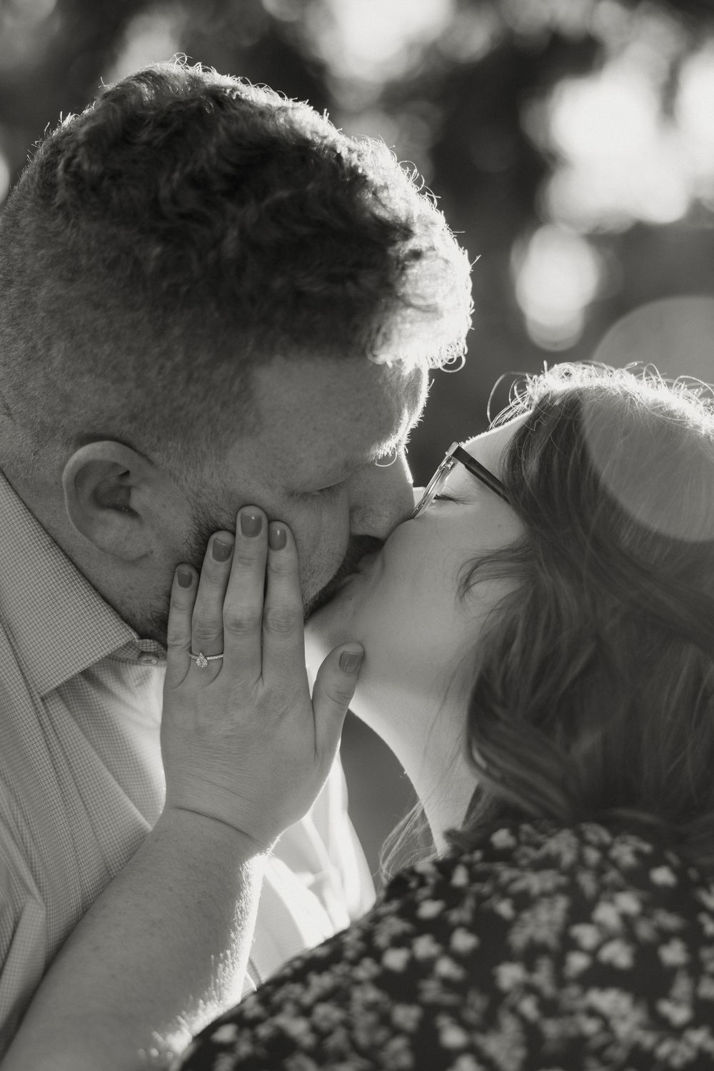 A romantic black and white photo sequence showing a couple sharing an intimate kiss.