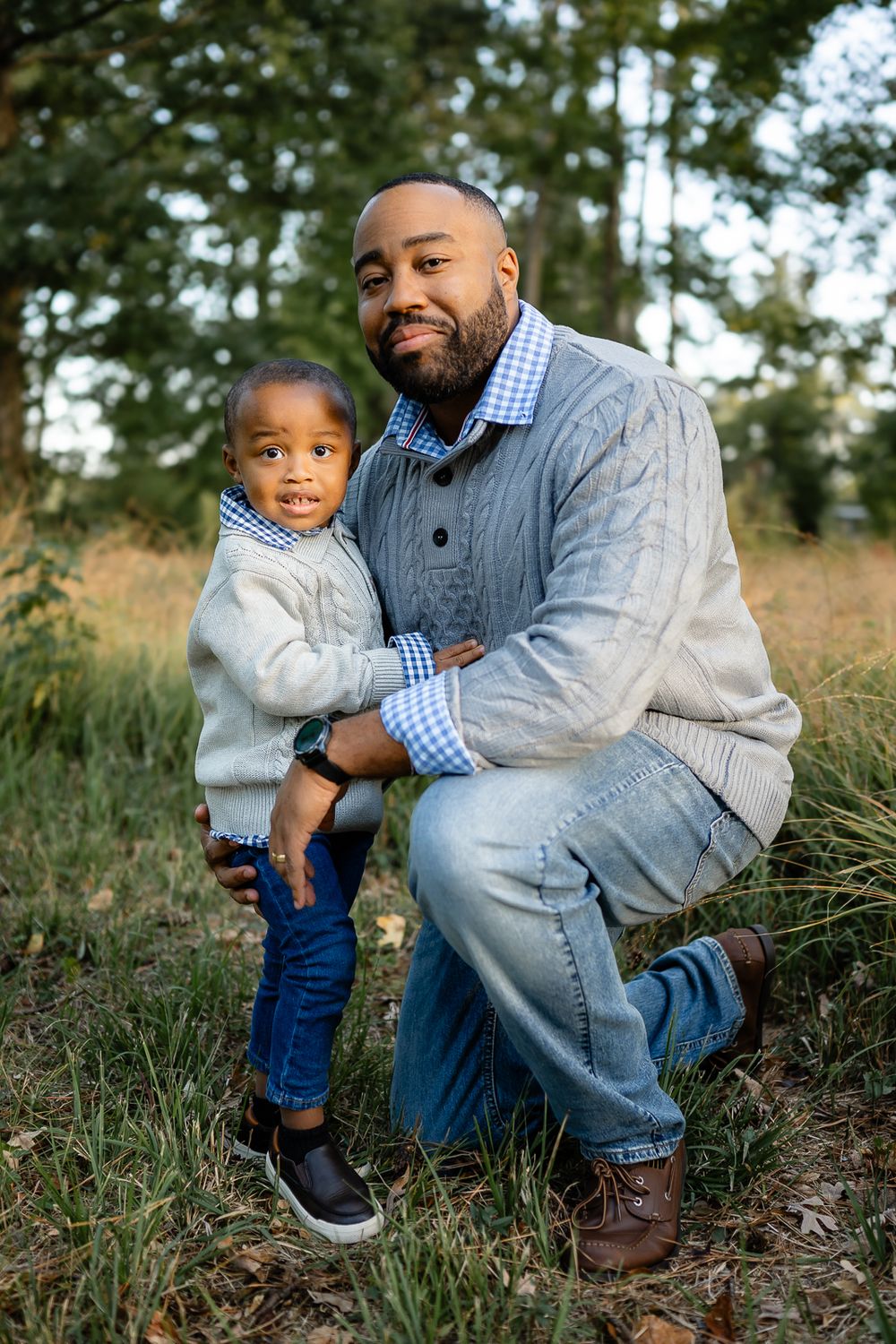Sweet candid moment between parent and child outdoors in casual clothing.