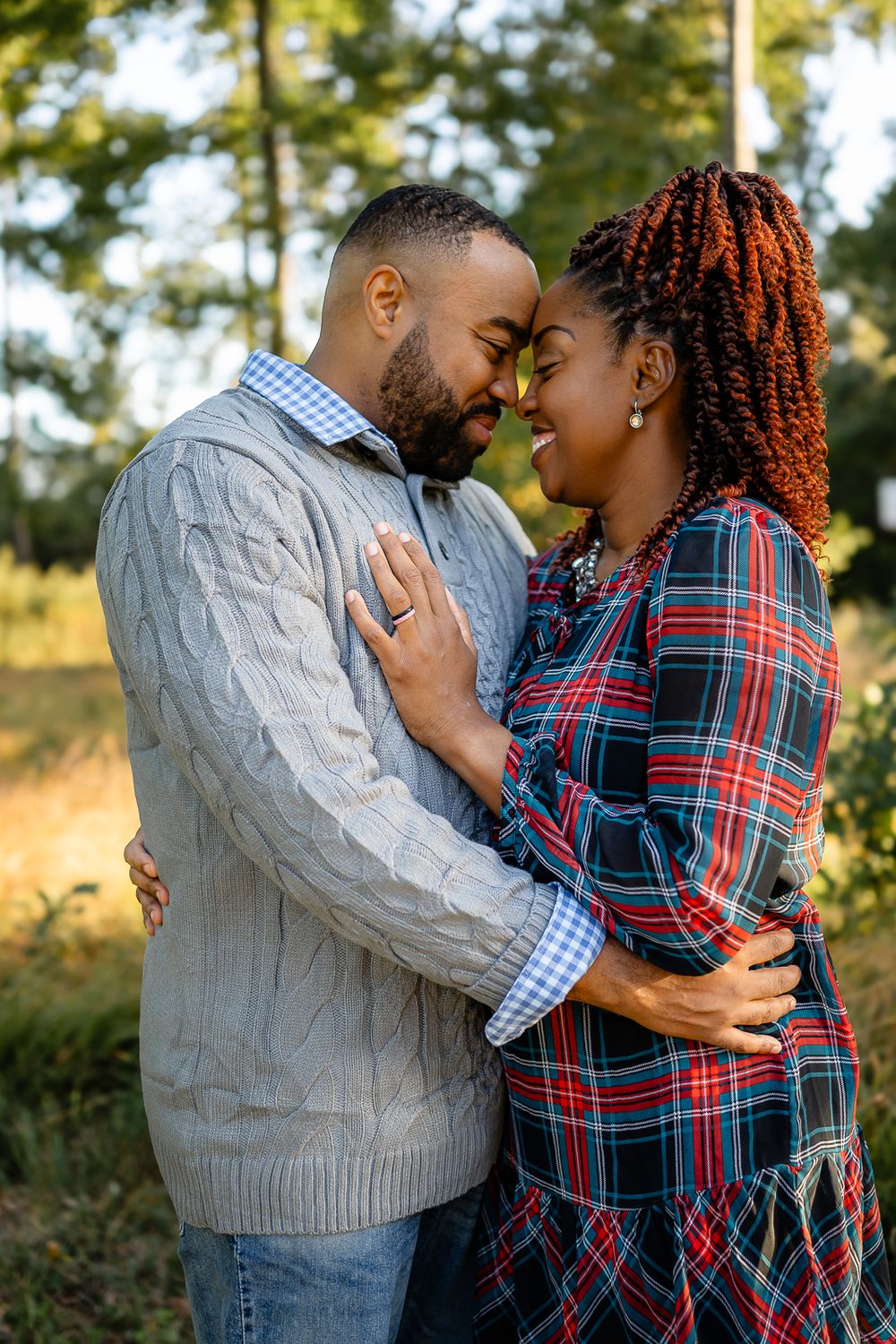 Intimate close-up of couple sharing romantic moment outdoors in casual sweaters.