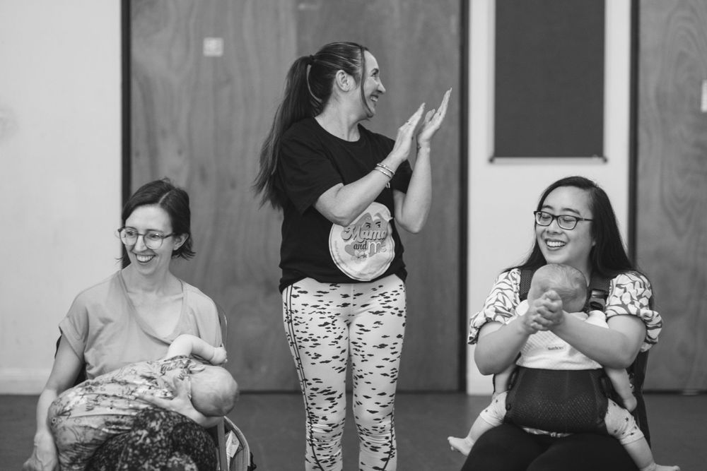 Group of parents with babies enjoying interactive dance class.