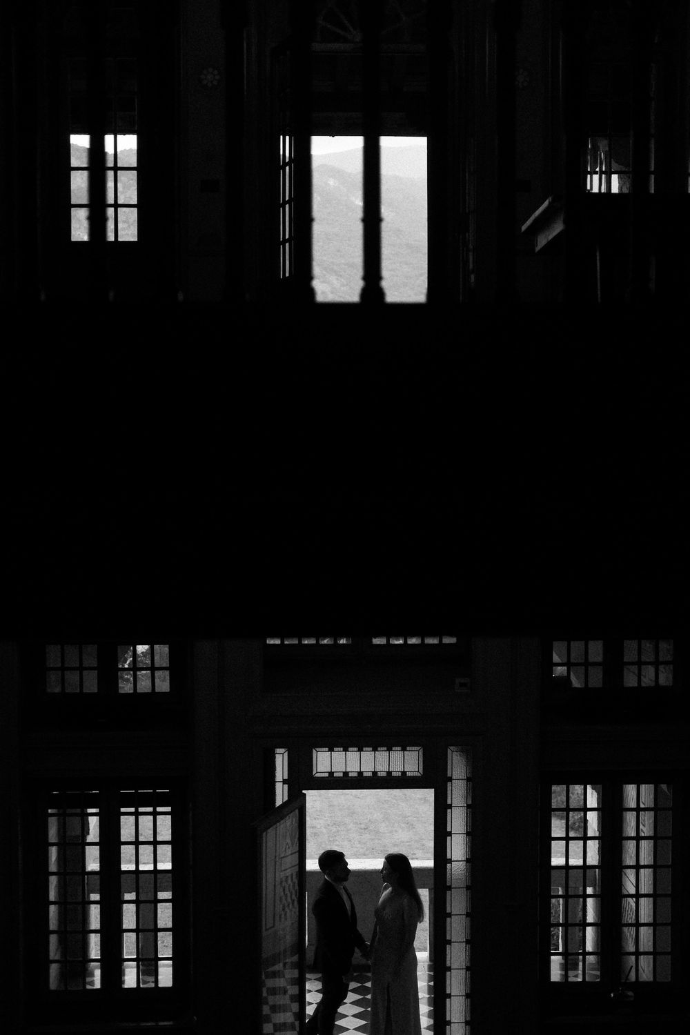 Black and white silhouette of couple in historic villa.