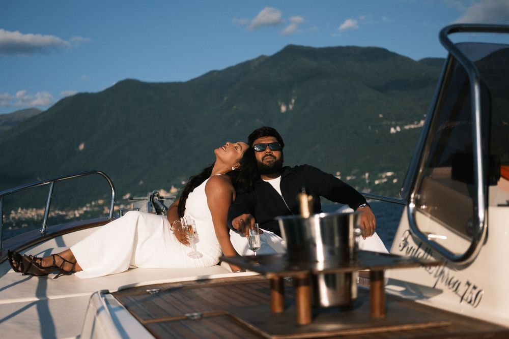 Couple enjoying champagne on Lake Como boat proposal.