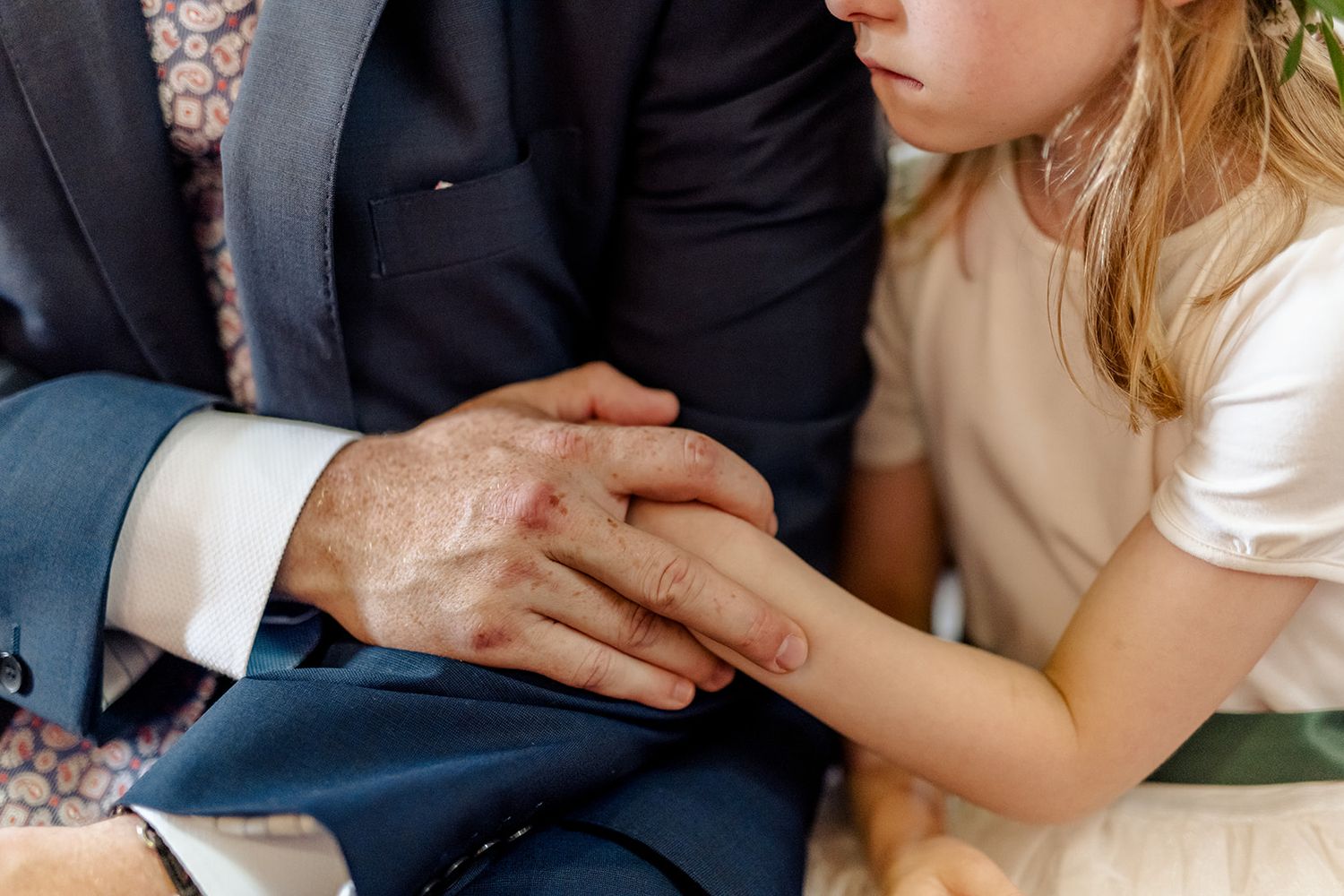 Close-up shot of hands og wedding guests during ceremony in county Sligo, Ireland.