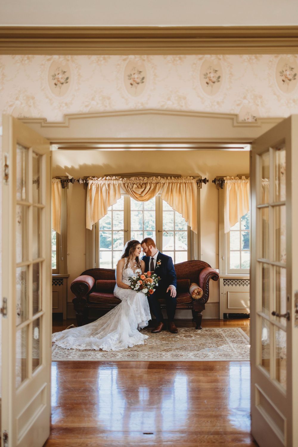 Elegant wedding venue interior with french doors, hardwood floors and natural lighting.