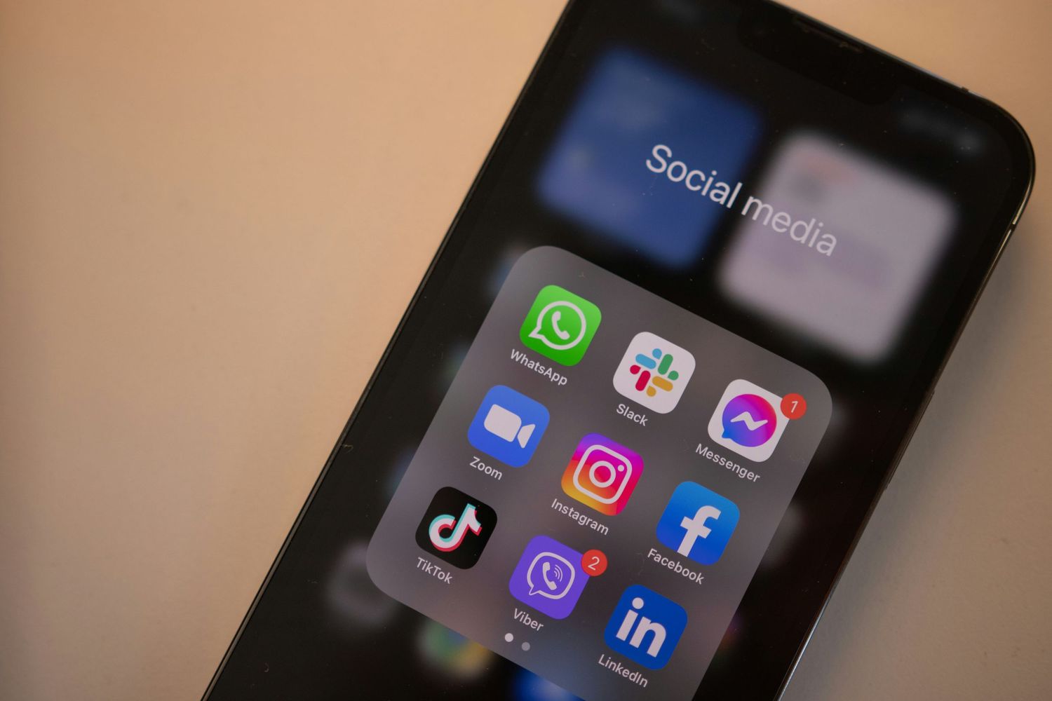 Smartphone screen displaying popular social media app icons including WhatsApp, Instagram and Facebook.