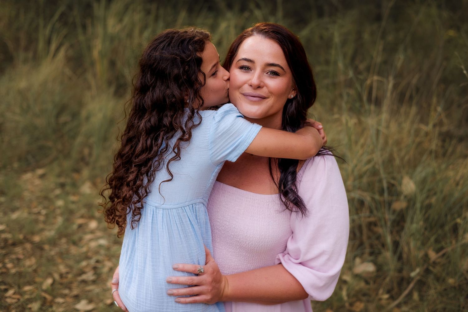 Fun and candid kids photoshoot in Nanango, South Burnett, with the children playfully exploring the shaded, bushy environment
