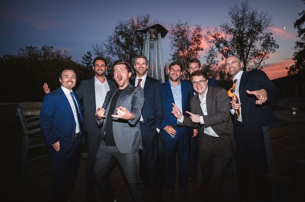 A group of friends pose together at dusk during cocktail hour at Drowned Lands Brewery Warwick, NY.