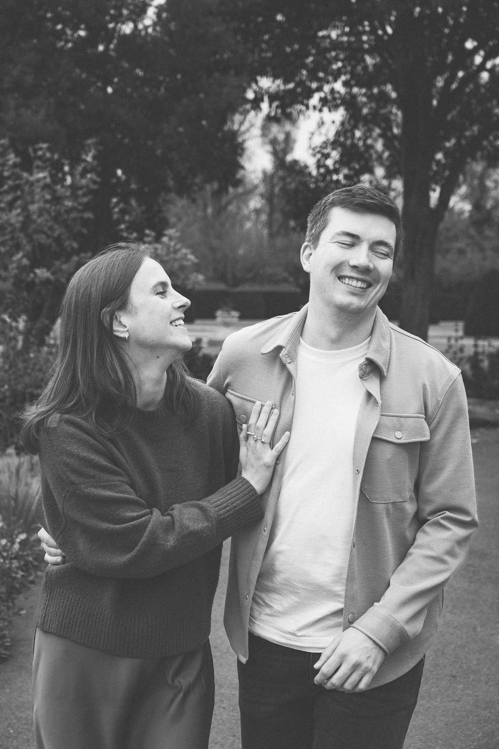 Playful black and white sequence of a couple engaging in lighthearted moments outdoors.