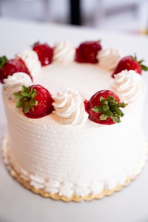 Strawberry shortcake decorated with fresh berries and whipped cream swirls.