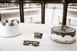 Collection of white wedding cakes with elegant decorative details arranged in a row.